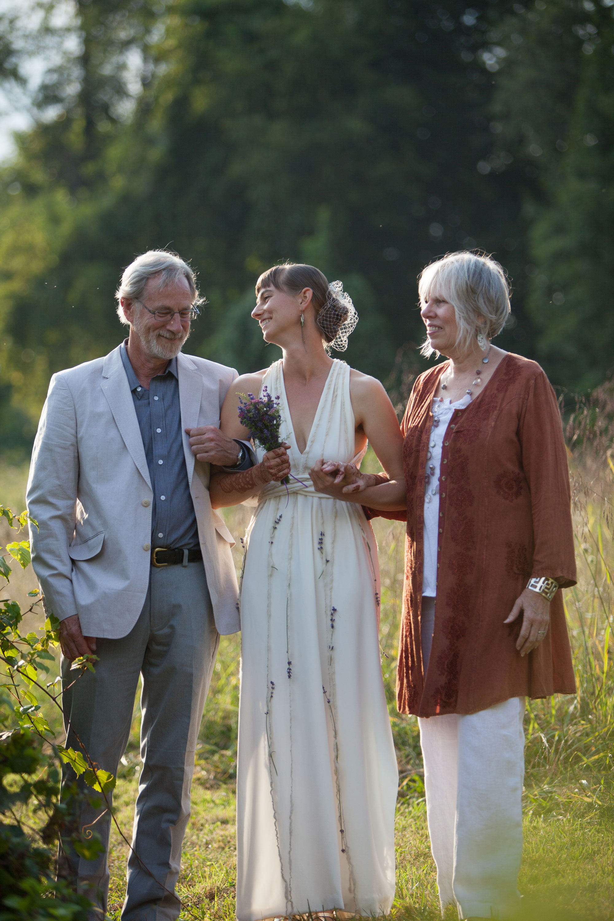 Bride with her parents getting ready to walk down the aisle