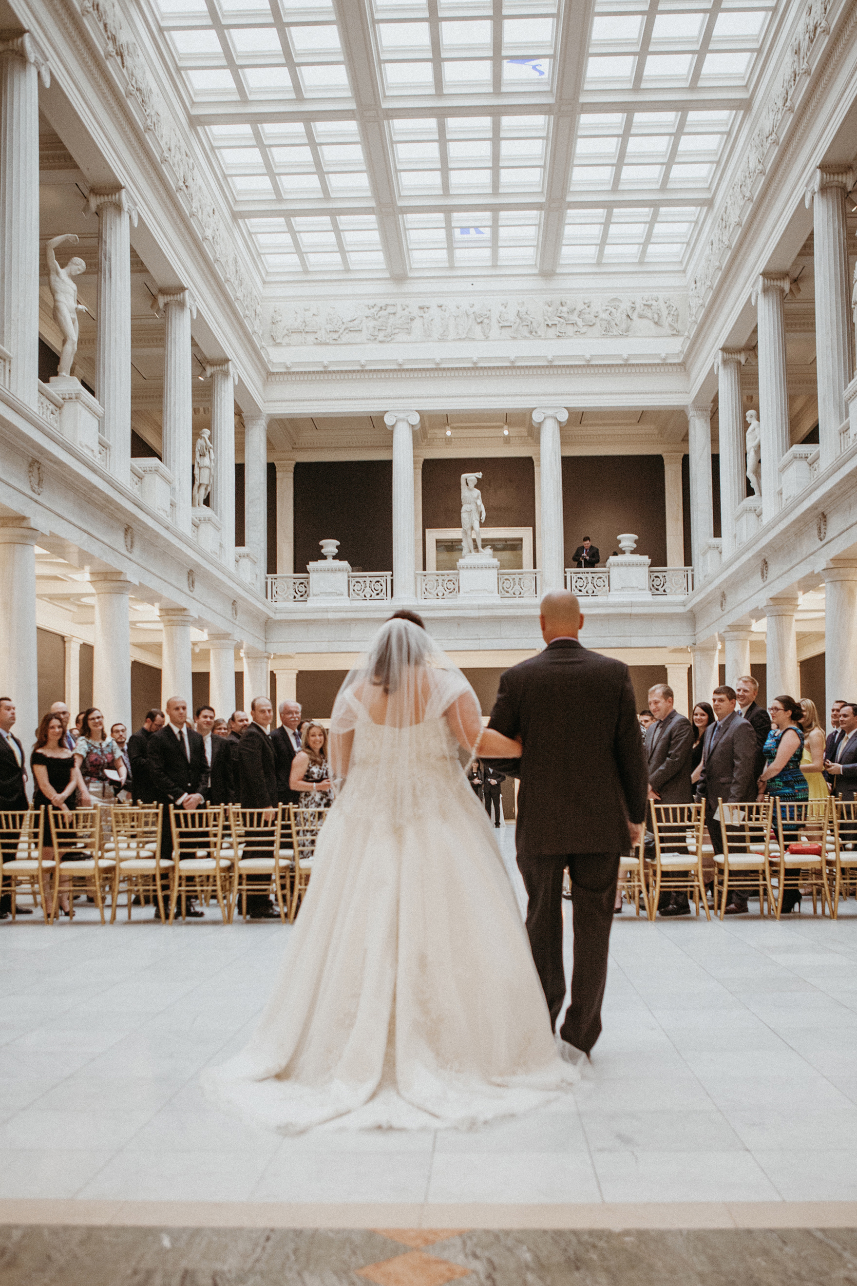 father of the bride and the bride walking down the aisle