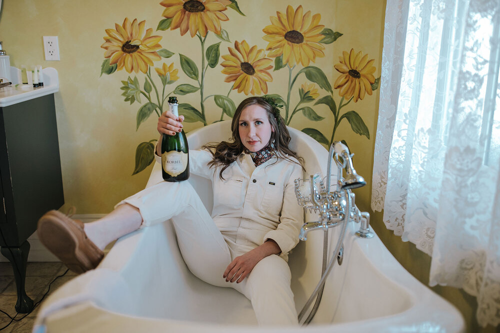 Bride in a bathtub with champagne
