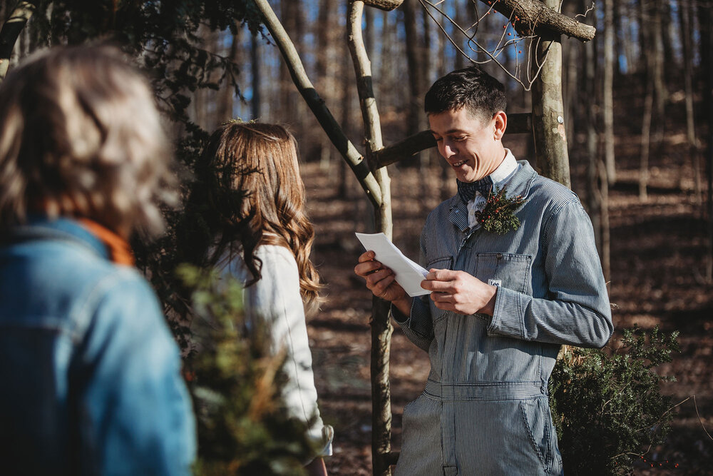groom reading his vows during his elopement
