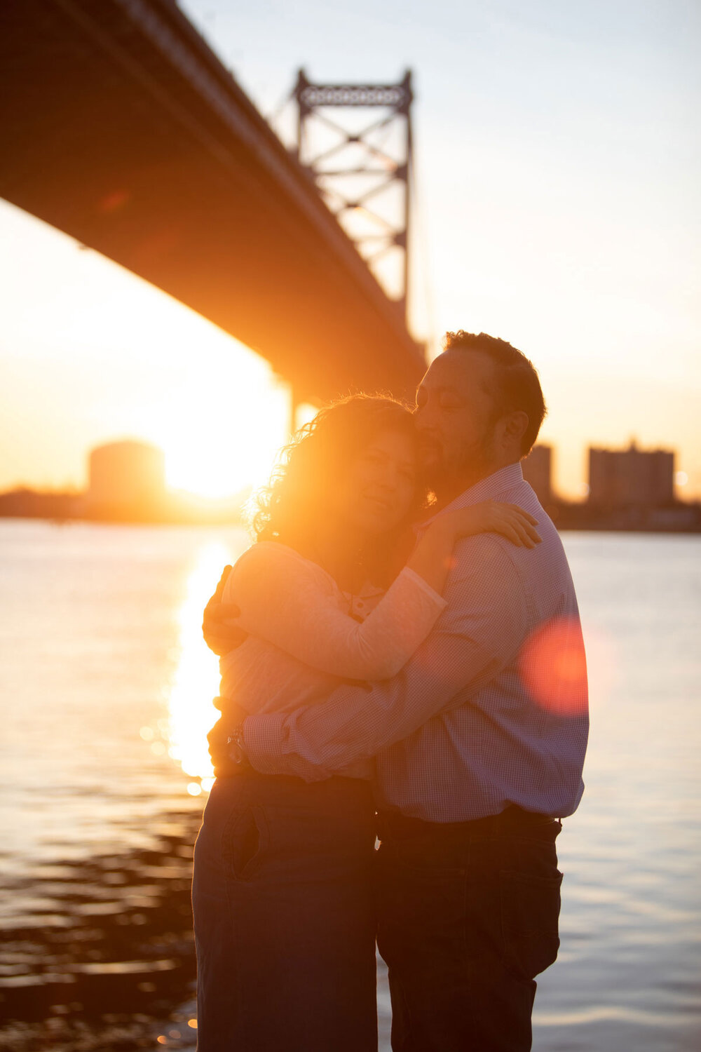 A couple kissing at sunrise at the Race Street Pier