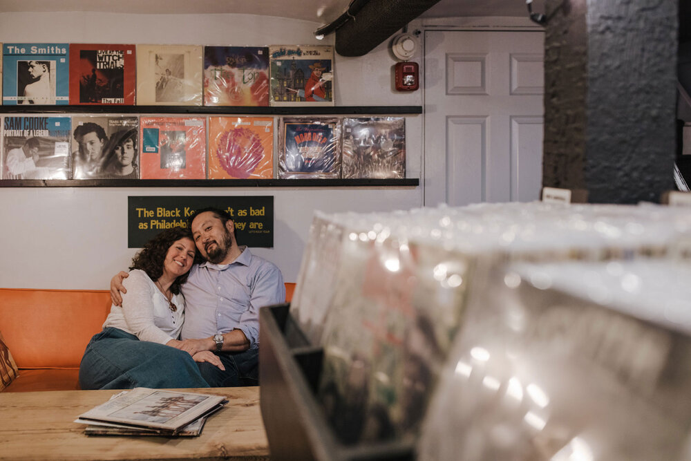 A couple snuggling at a record shop in Philadelphia