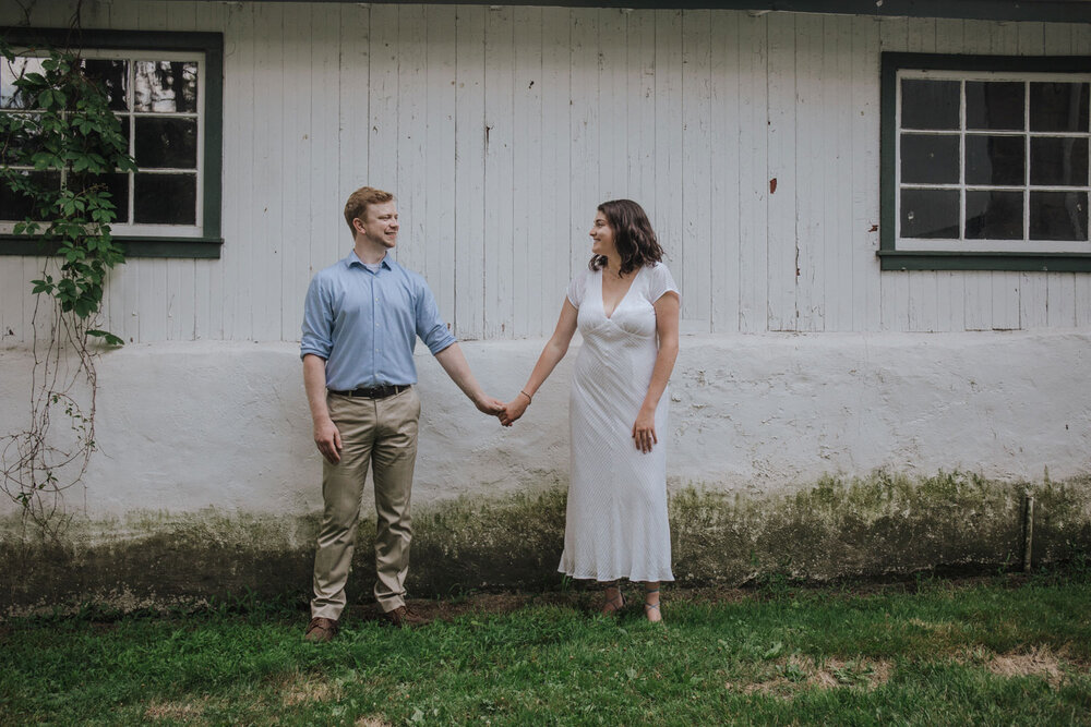 A couple holding hande in front of a building at the Lehigh Valley Parkway