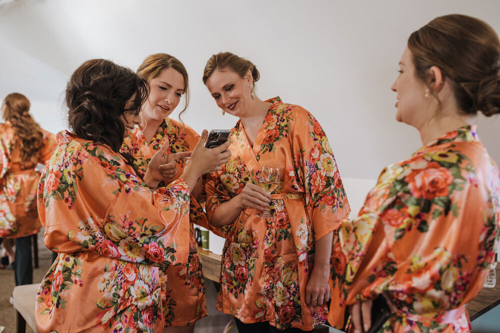 bridesmaids joking around while they get ready