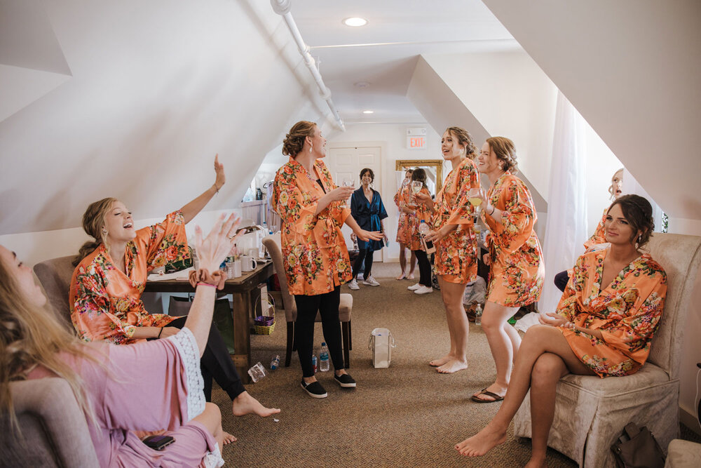bridemaids dancing while they get ready for the wedding