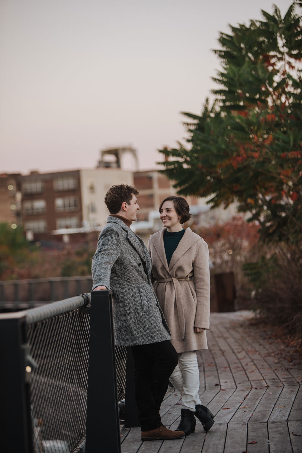 An engaged couple getting photographed at sunrise