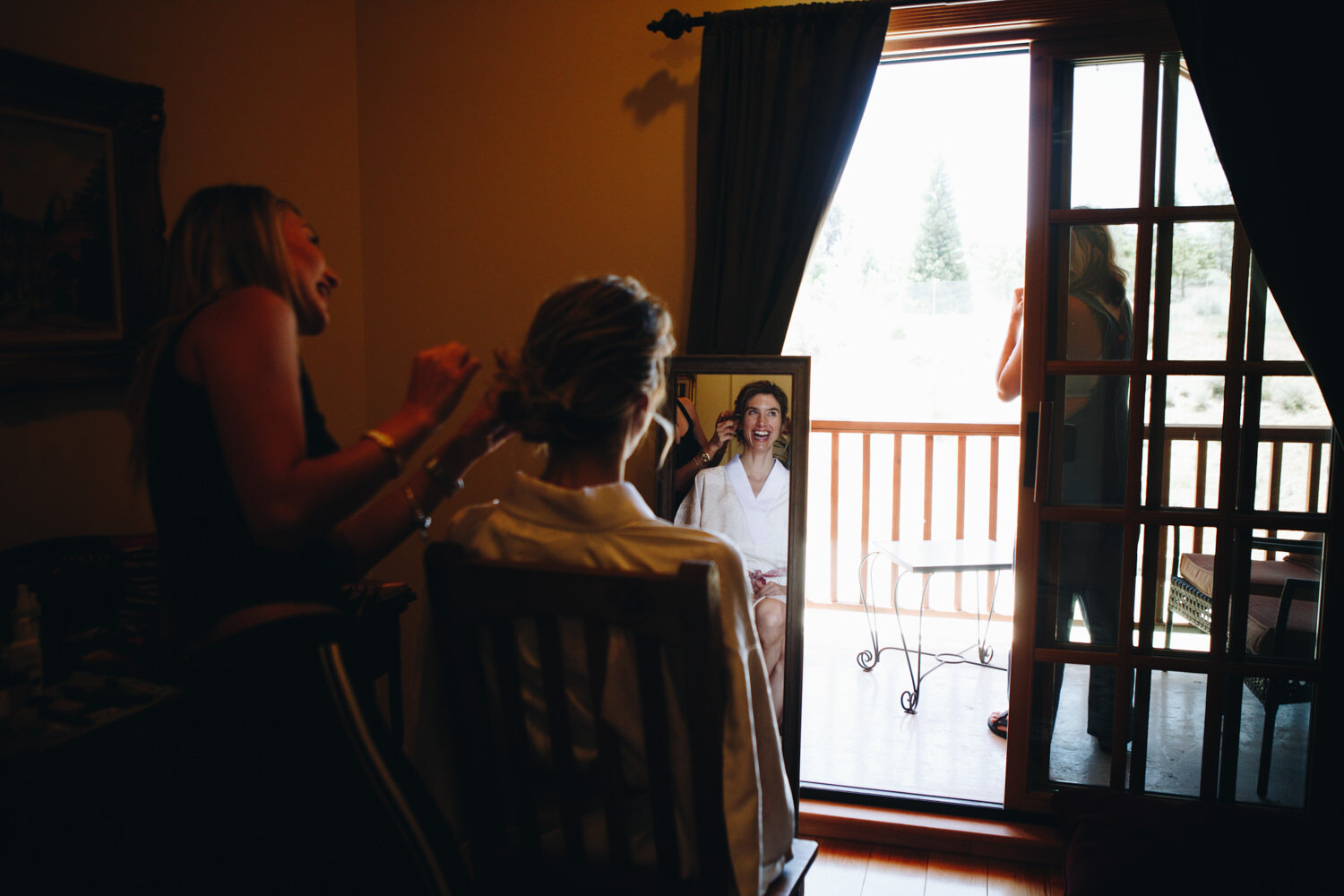 bride looking in the mirror while getting ready for her intimate wedding