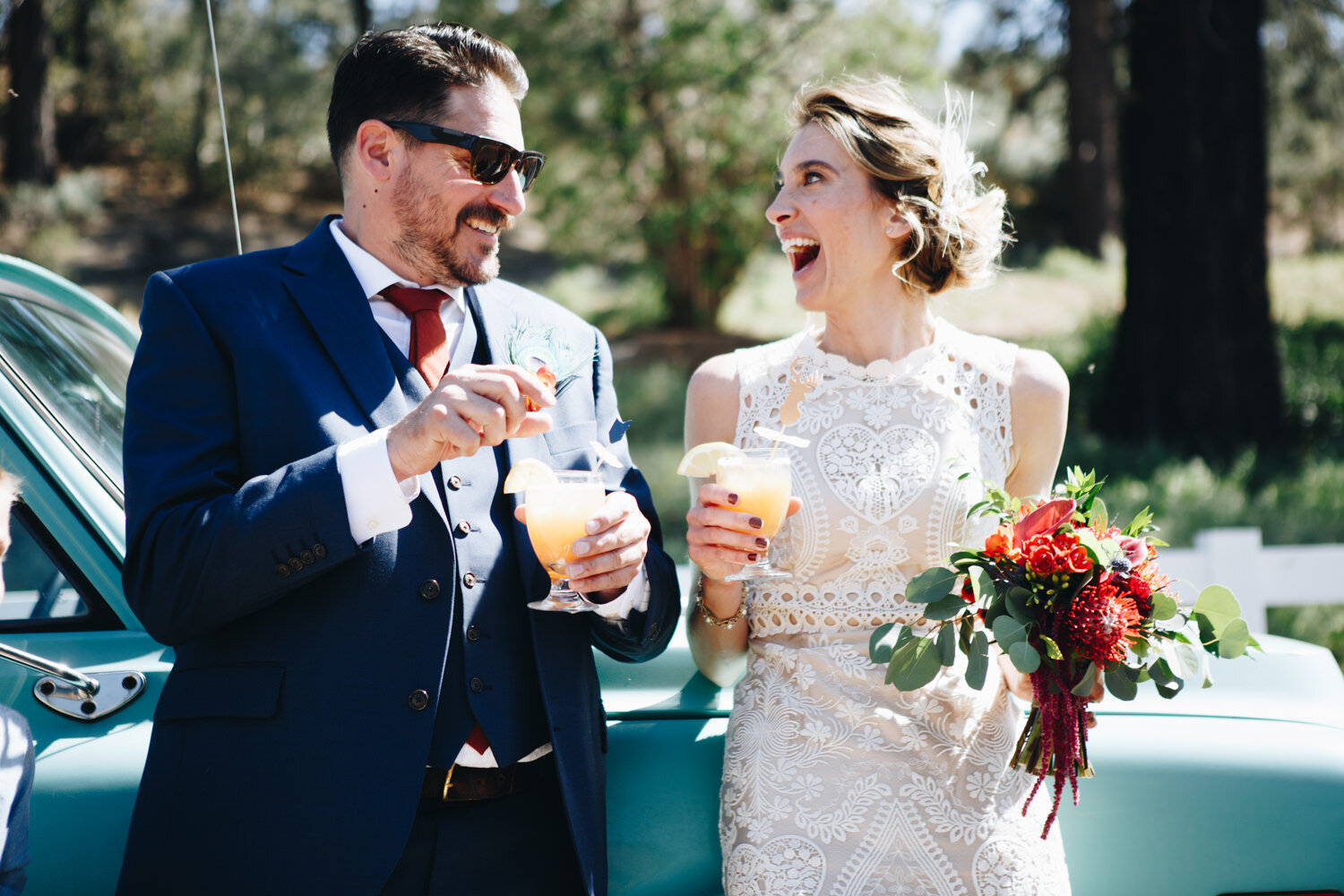 Bride and Groom smiling while holding cocktails