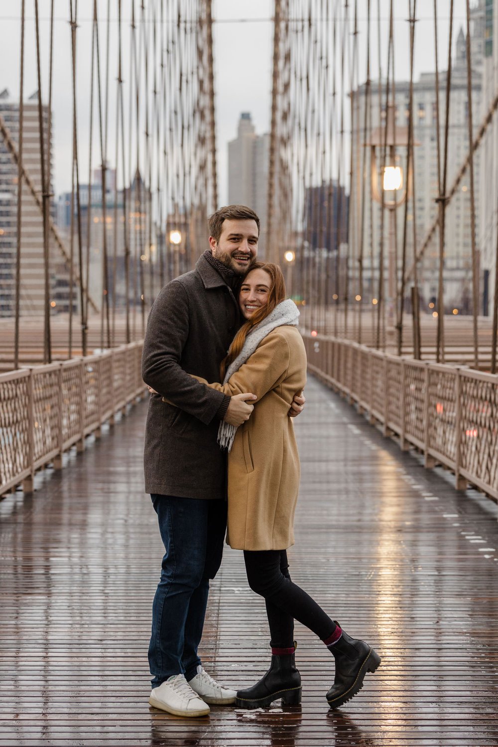couple posing during an engagement session on the Brooklyn Bridge