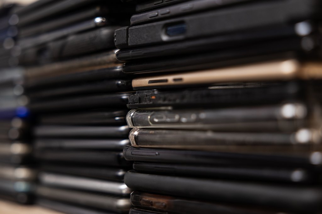 Stack of used cell phones photographed for an electronics recycling company's website.
