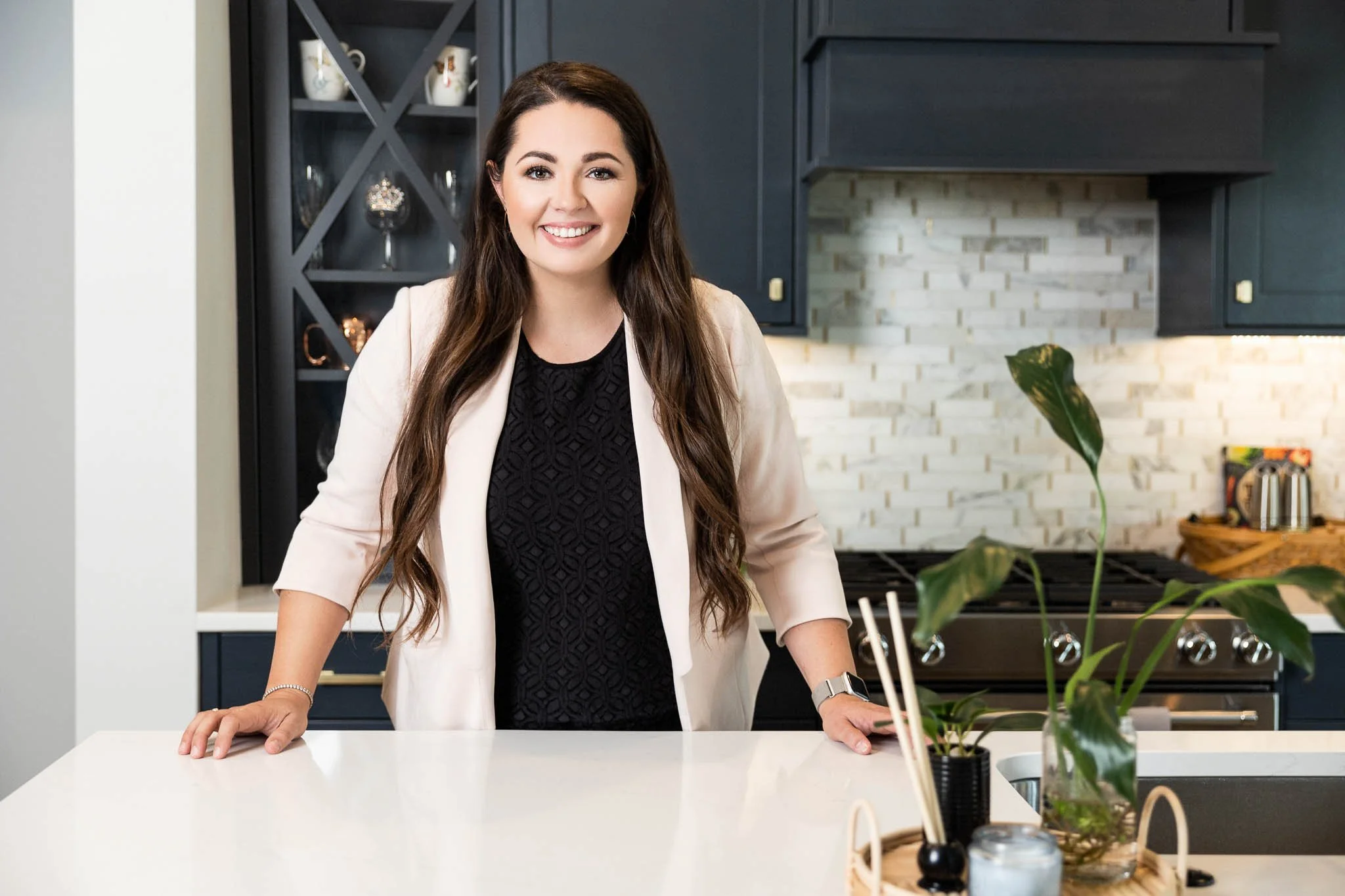 Small business owner during a personal branding photography session in Boise, photographed in a modern kitchen workspace