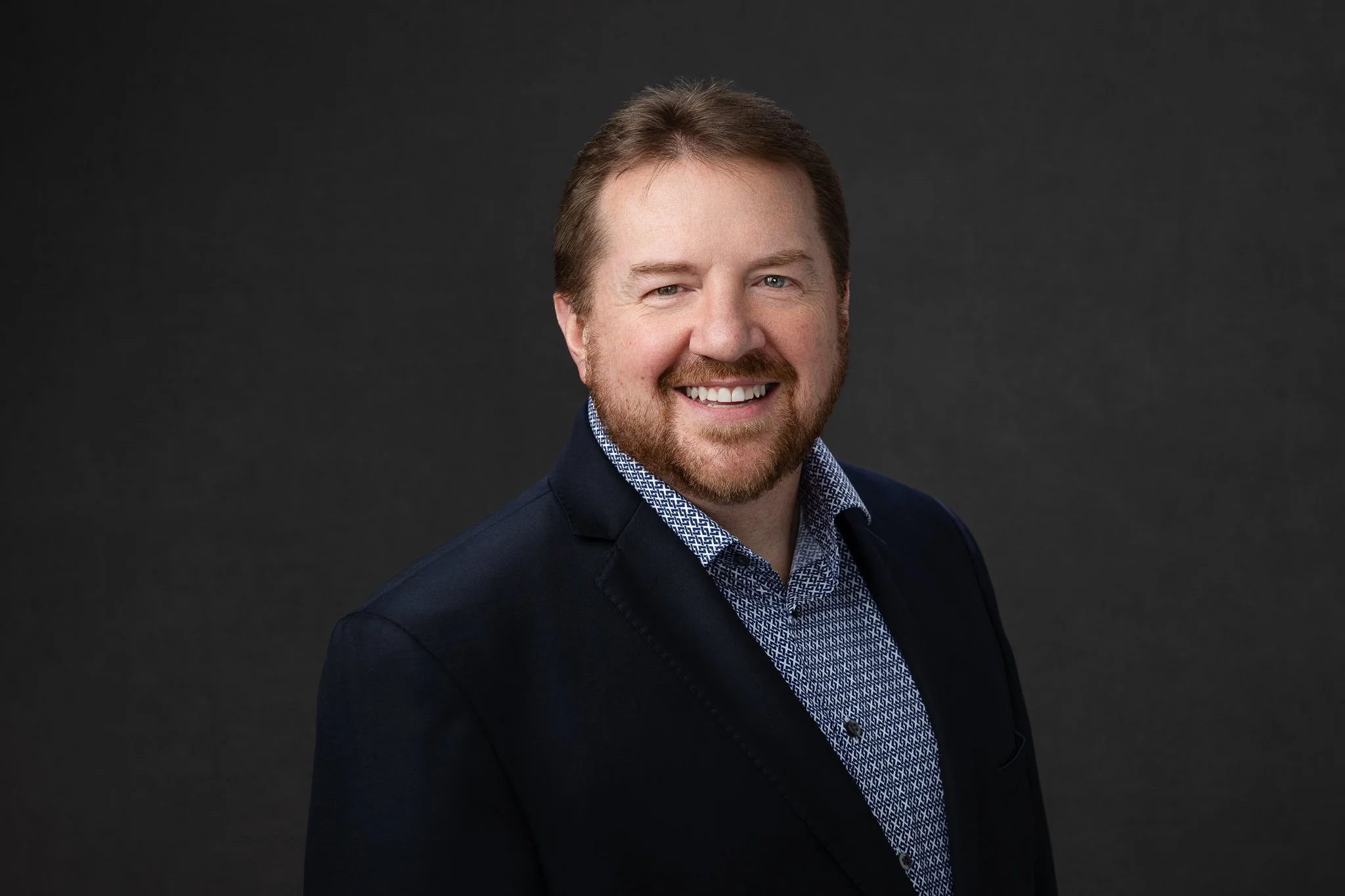 Professional headshot of a Boise businessman on a dark gray background