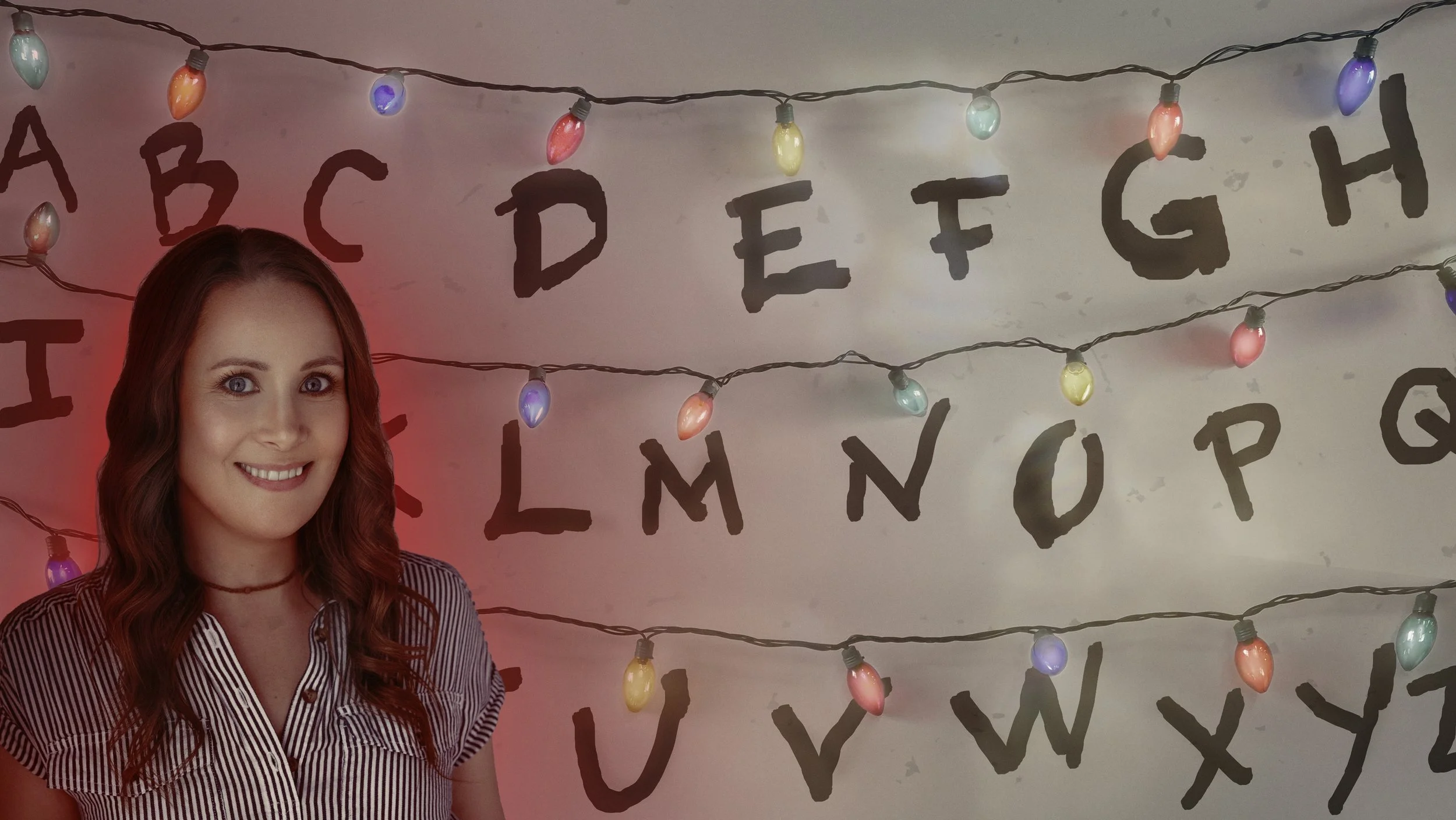 image inspired by Stranger Things showing an old headshot in front of a wall with christmas lights and hand written alphabet letters