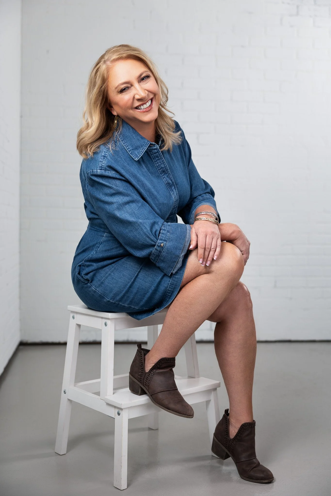 Relaxed seated professional portrait on a white studio background