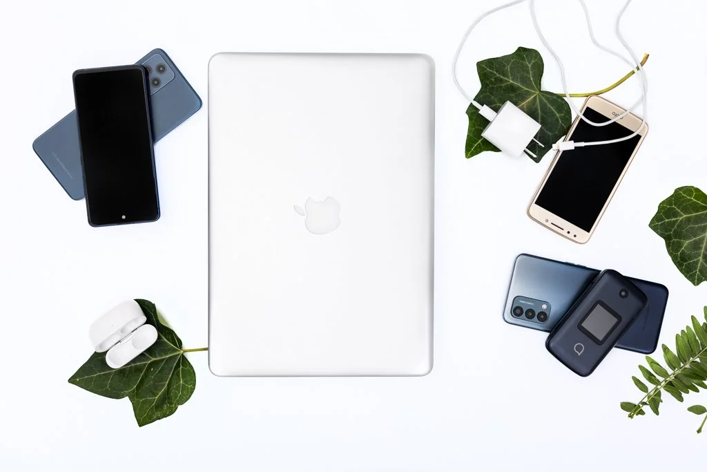 Overhead photograph of a laptop, cell phones and electronics created as custom website imagery for a recycling business.