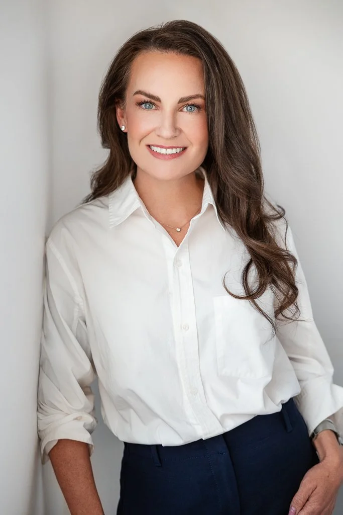 leaning on the wall pose in natural light headshot