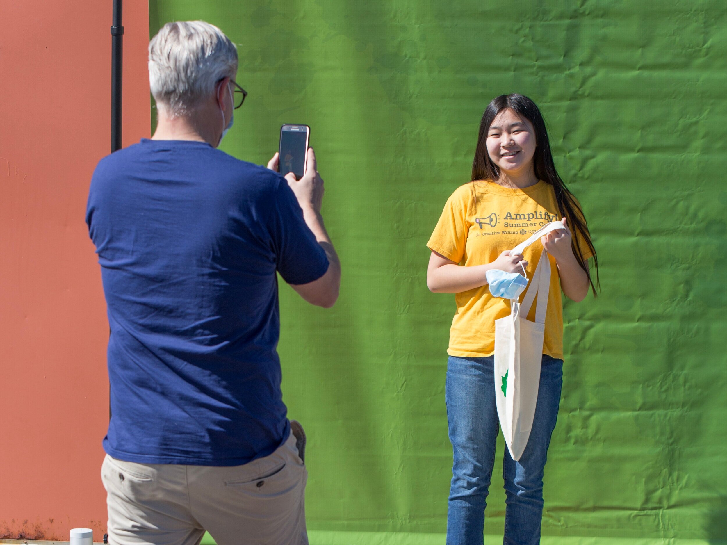 This student's proud parent snaps a picture.