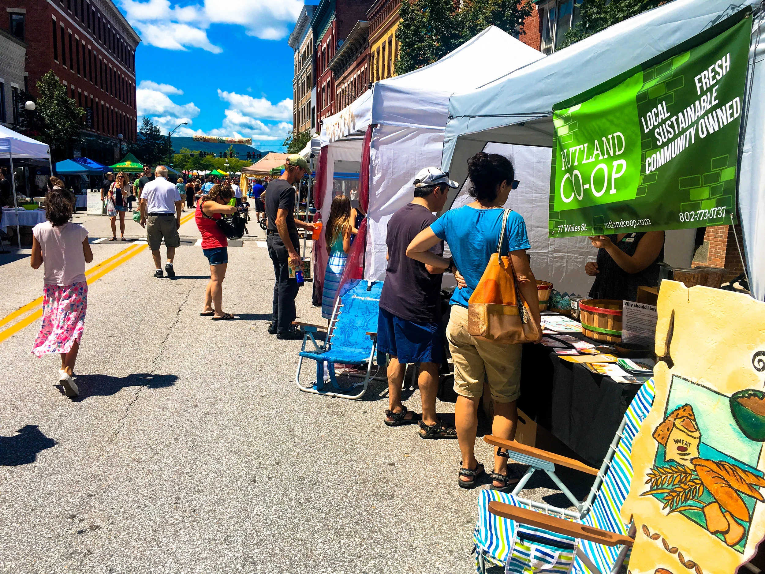 Attendees browse vendor tents at the Downtown Rutland Street Party & Sidewalk Sales.