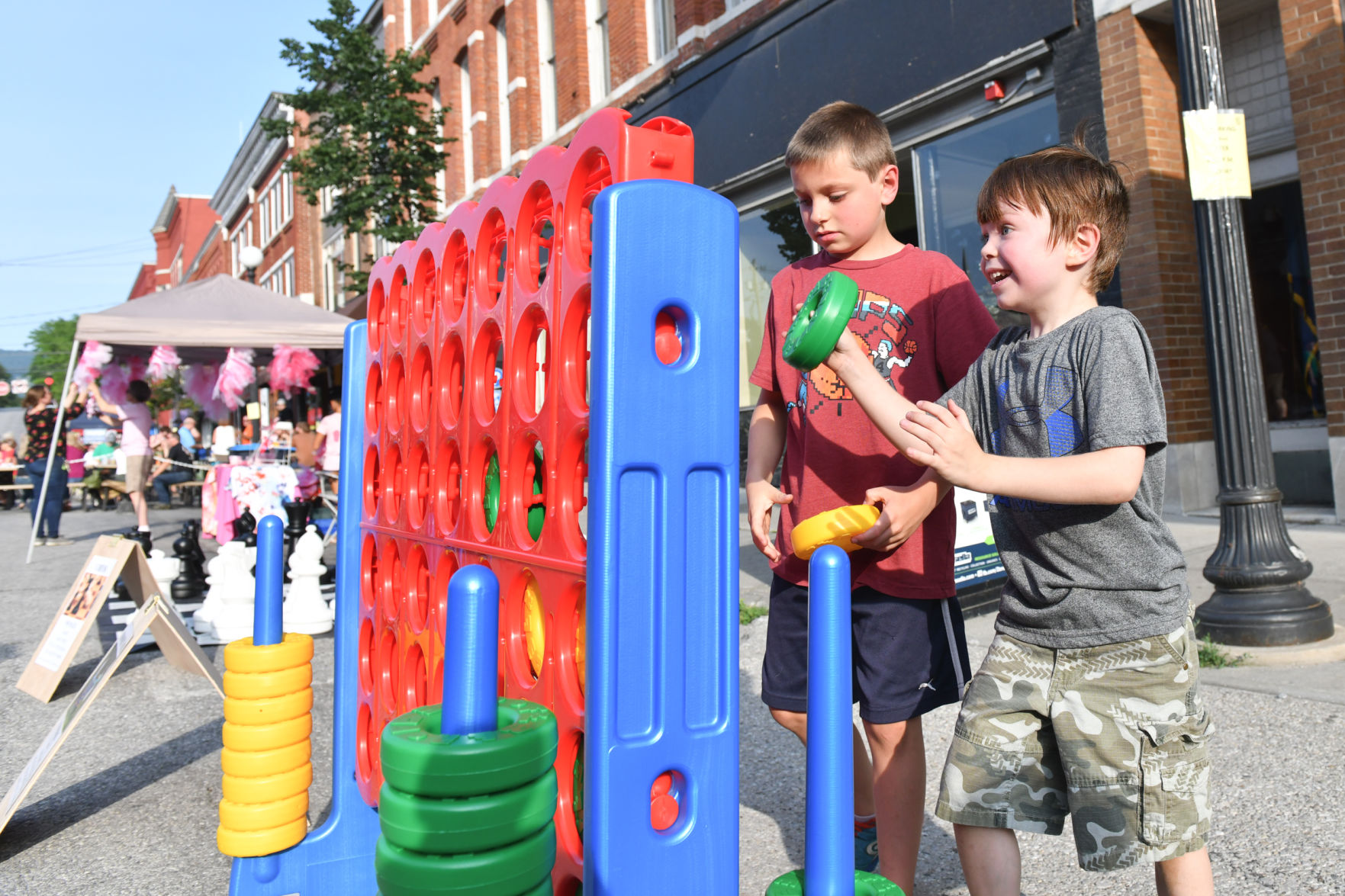 Two local children play giant connect 4 at Friday Night Live on July 13th, 2018.