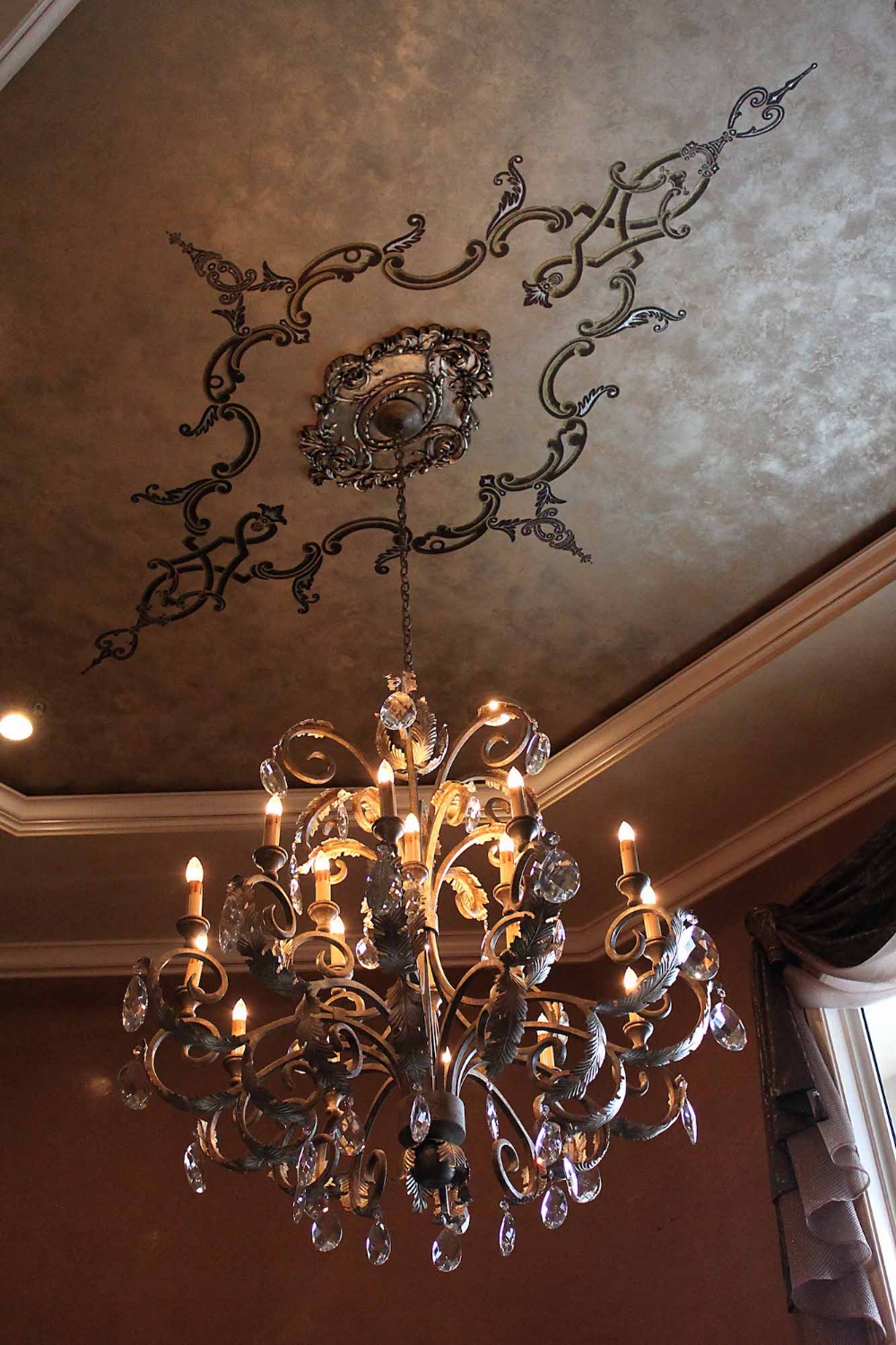  This ceiling was plastered with multiple metallic plasters accompanied with a custom embossed design with a textured plaster &amp; highlighted with gold and silver metallics. 