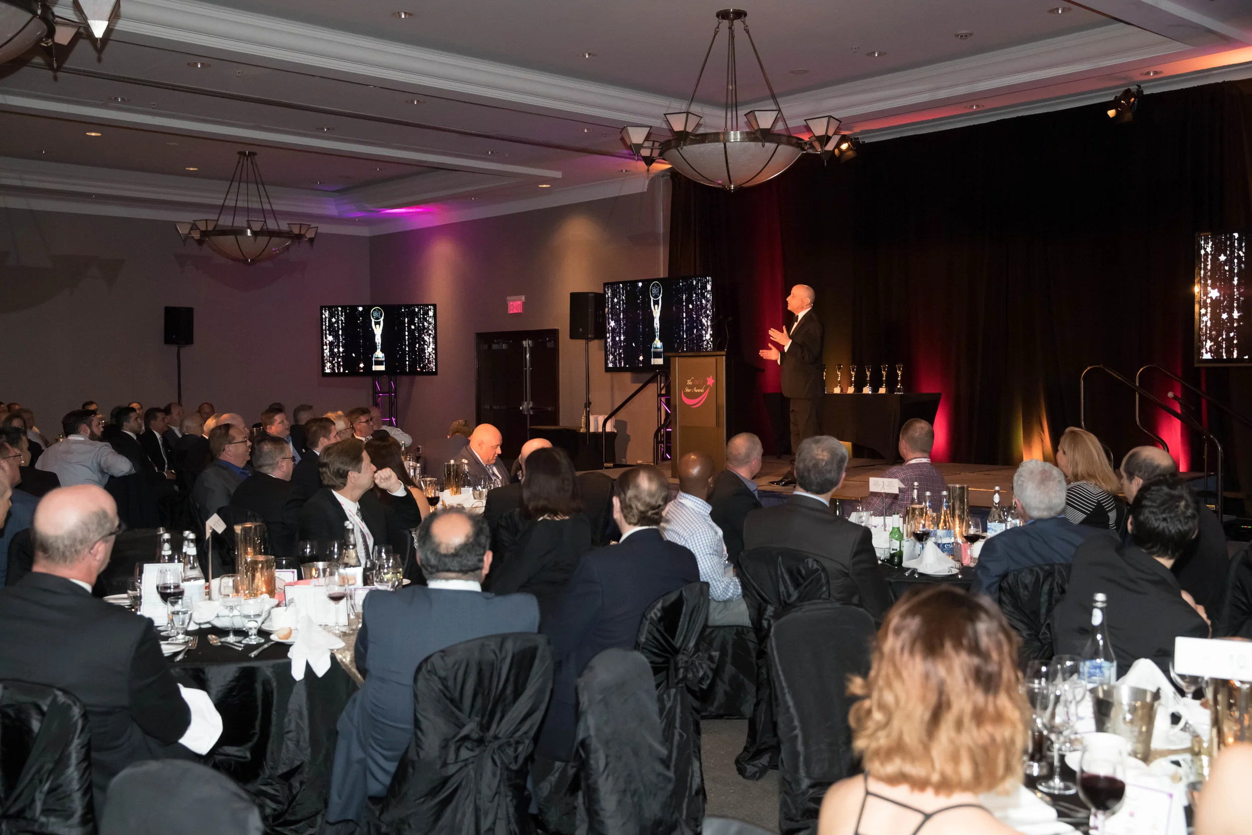 Evening Host and Comedian Scott Faulconbridge emcees the annual DCI Star Awards which commenced during the evening Gala Dinner of the 2017 DCI Business Summit.