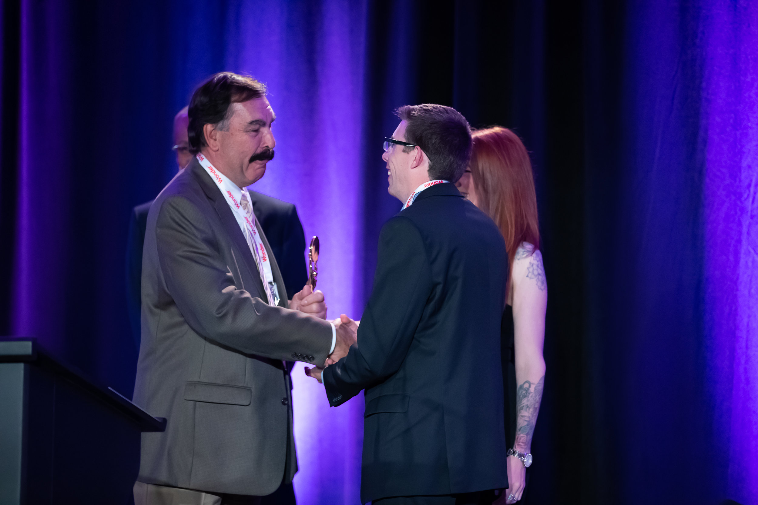 Bob Brema (William M. Dunne &amp; Associates) shakes hands with DCI Treasurer Nigel Oliver of Vince's Market and Star Awards Presenter Melissa Lynne-Schaffer