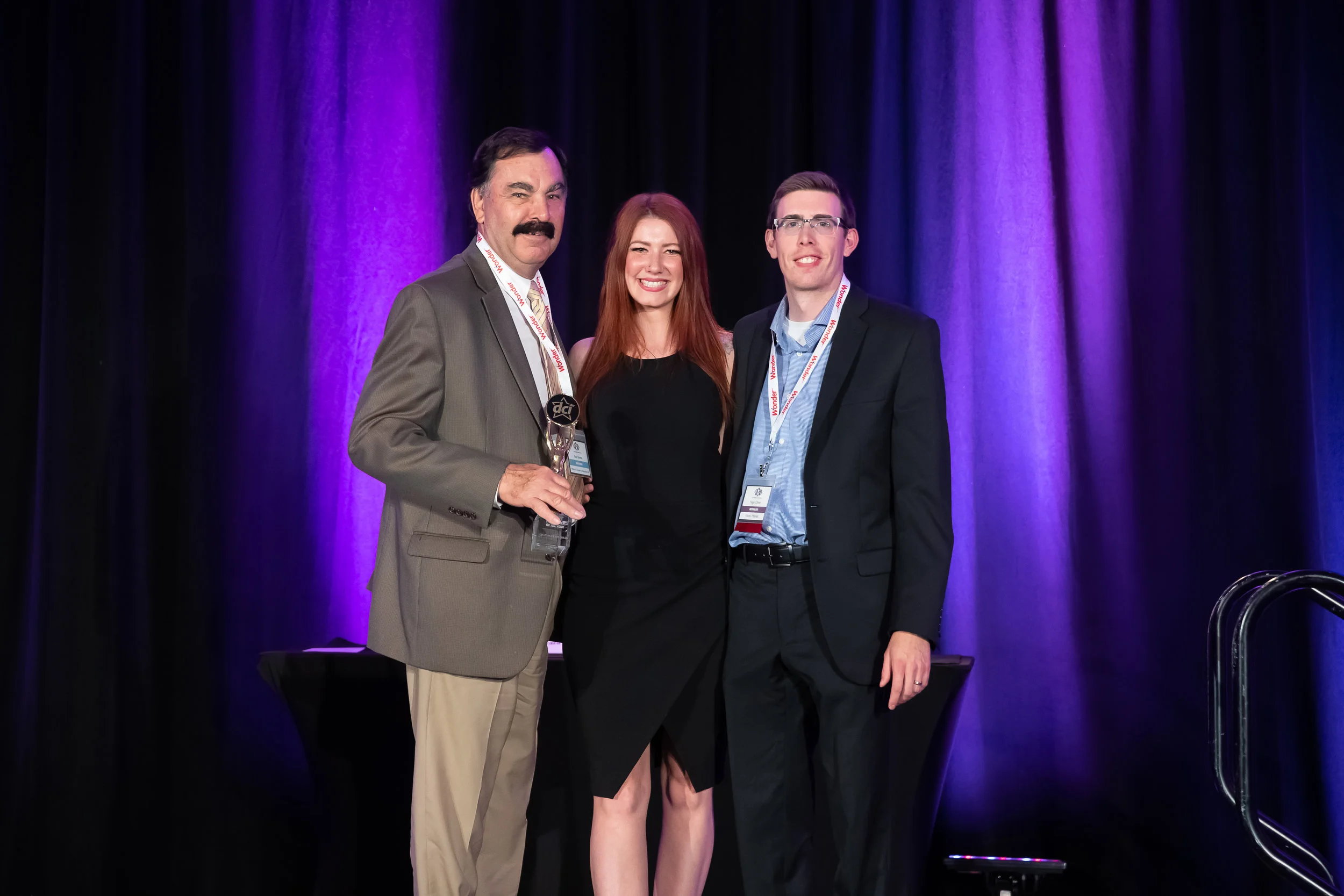 Bob Brema (William M. Dunne & Associates) accepts the award on behalf of Chapman's with Star Awards Presenter Melissa Lynne-Schaffer and DCI Treasurer, Nigel Oliver of Vince's Market