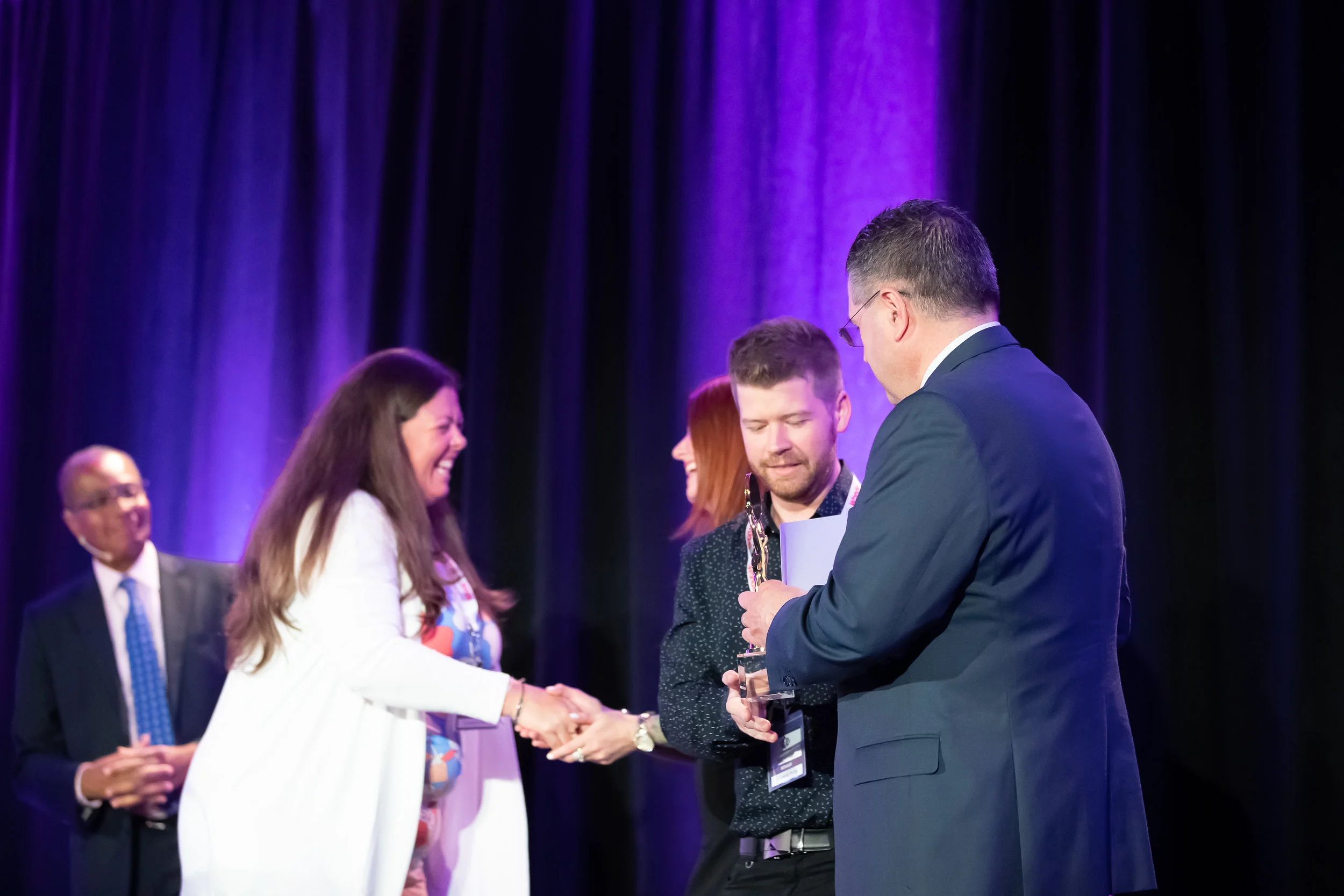 Christy McMullen of Summerhill Market shakes hands with Star Awards Presenter Melissa Lynne-Schaffer