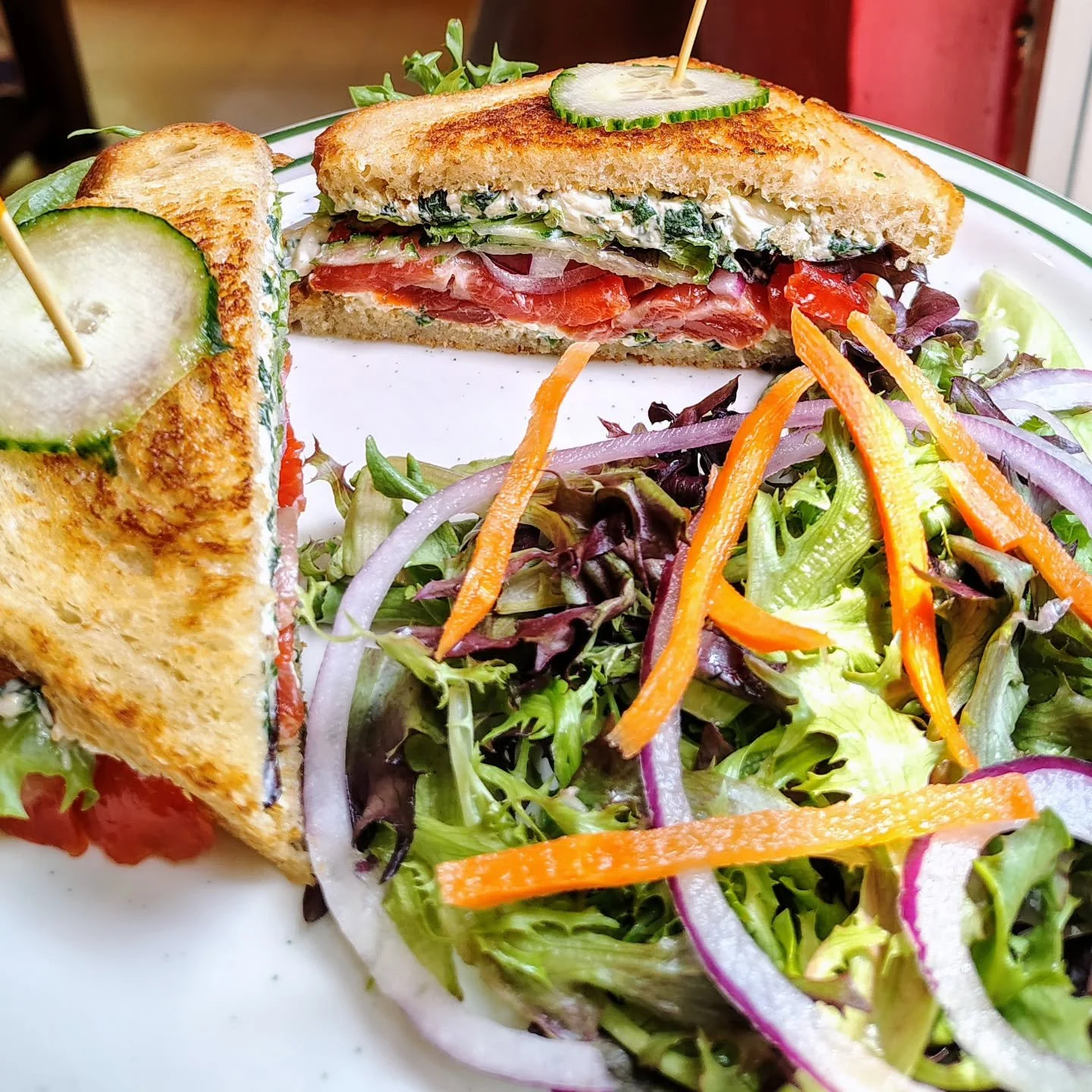 Lunch Special,  house cured Gravlax with creamy spinach and cheese spread, cucumbers, sliced onions, mixed greens on butter grilled sourdough toast.