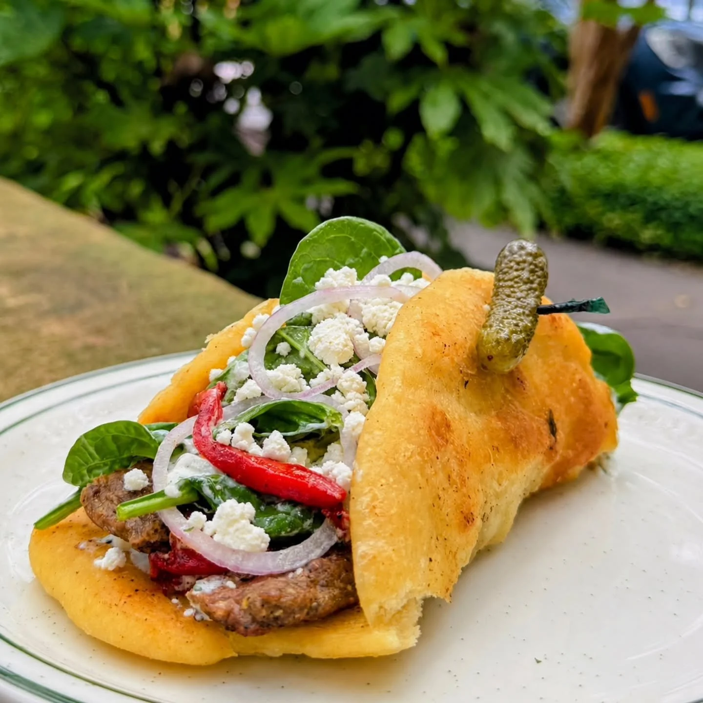 Shaved Lamb Gyros 
Shaved lamb, fire roasted red peppers, fresh spinach, sliced red onions, crumbled feta cheese, and house tzatziki sauce,  wrapped in freshly baked naan bread.