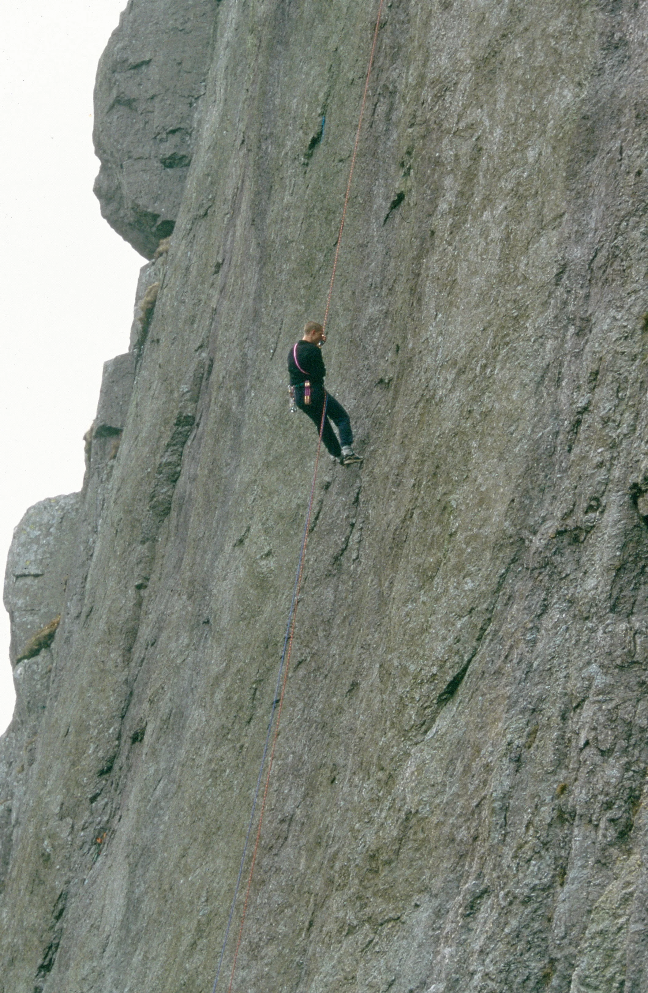 Abseiling down to check the protection on Indian Face E9 6c, prior to making the third ascent in 1996. Photo: Gresham collection