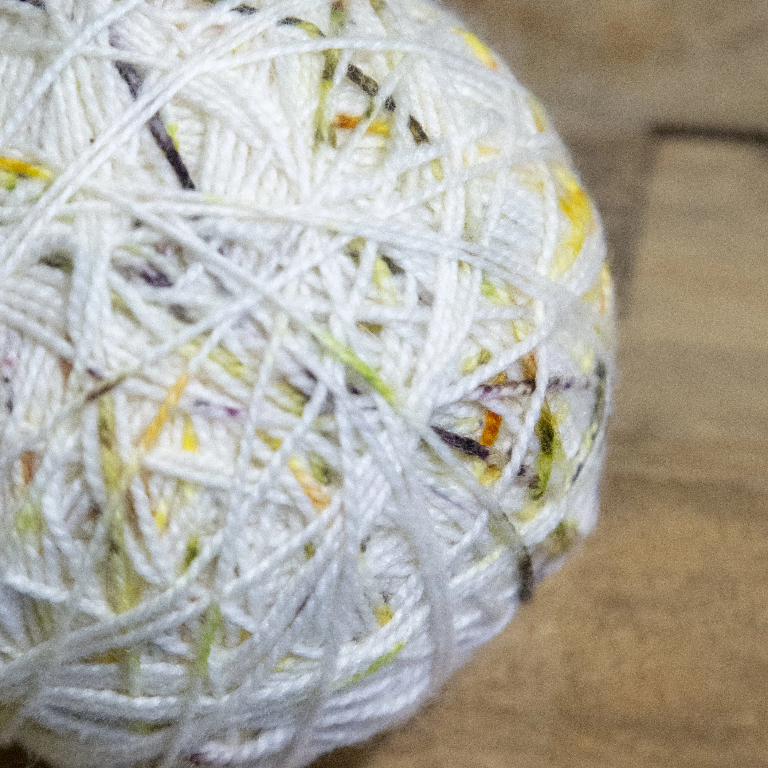Ball of white speckled yarn