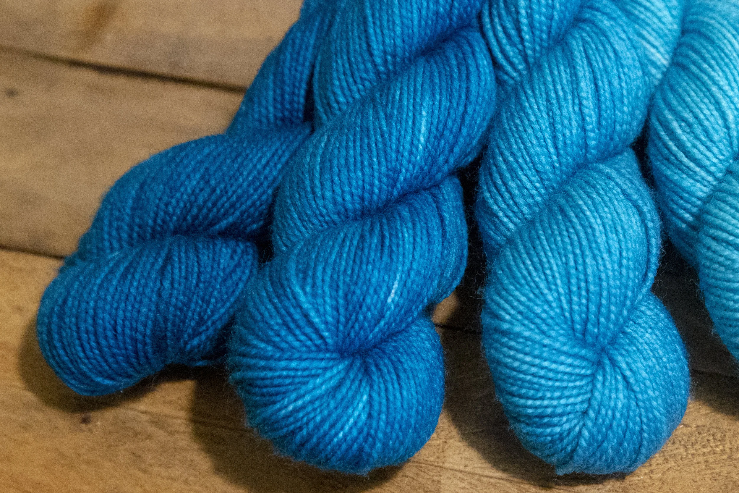 Four skeins of blue ombre yarn