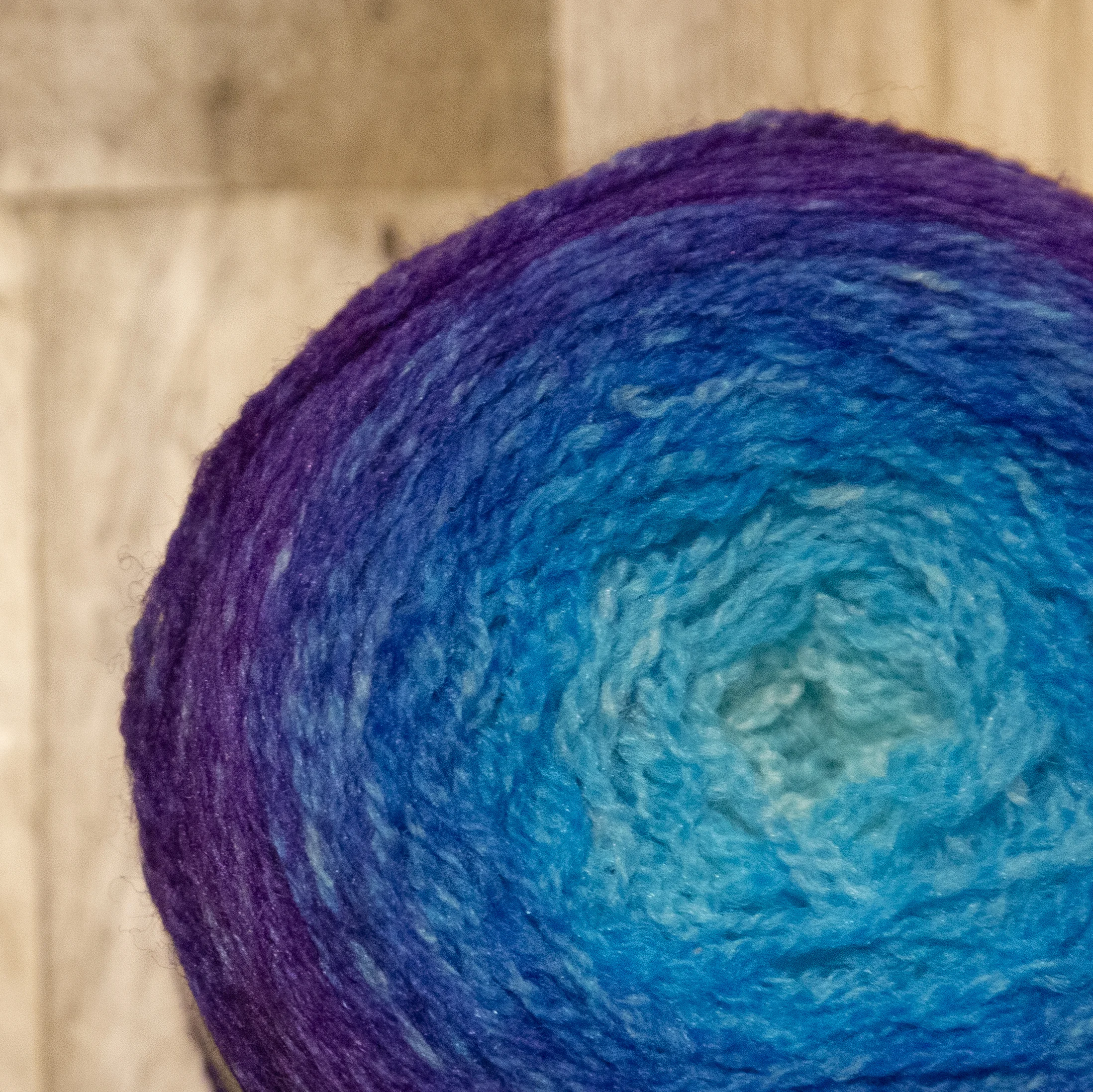 Cake of blue and purple gradient yarn