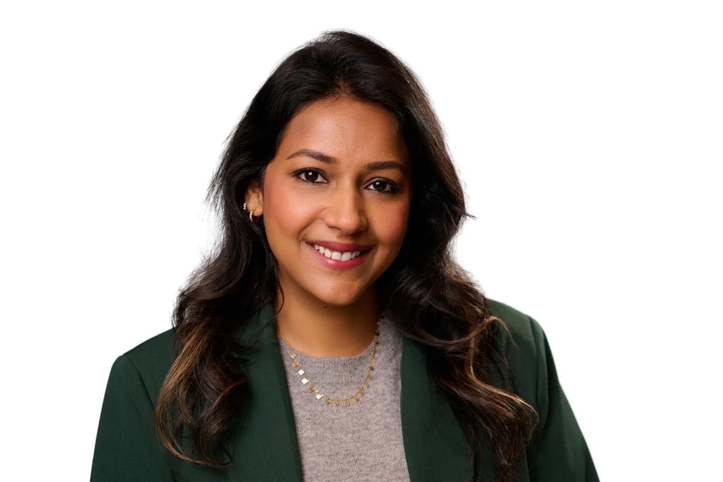Portrait of a woman with dark hair and a green jacket at On-location headshot station in Denver providing professional portraits for corporate conference attendees