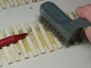  The pencil is pointing to the ragged burrs on the ties left from the sanding. I use a wire brush to clean these off with a fast scrubbing motion and revacuum. This is a quick process.&nbsp;  If desiring a very detailed tie (in O scale) I have next u