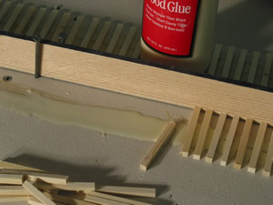 I use Titebond yellow glue. I'll run a bead of glue about 18" and spread with a stick, intentionally leaving a gap on the spline-side. One end of the tie is placed in the glue and then slid through the glue and up against the spline. This keeps the 