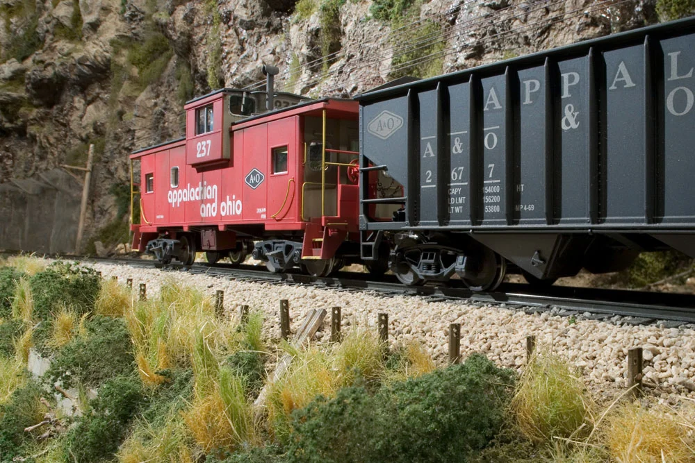 Only a month in service, A&O cab $237 follows obediently behind yet another coal drag.