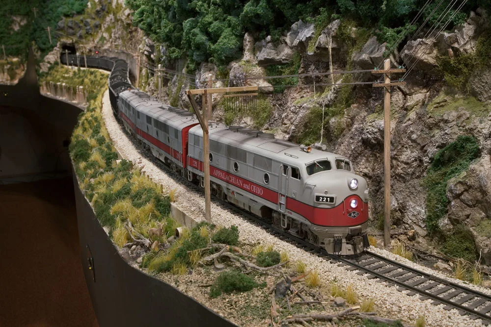 A trio of F3s leads a coal extra through the river gorge.