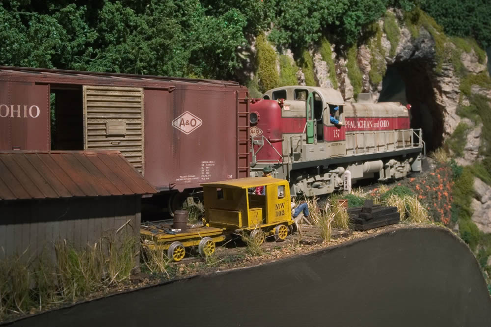  RS3 #137 rolls by milepost 234 and a relaxing section crew. 