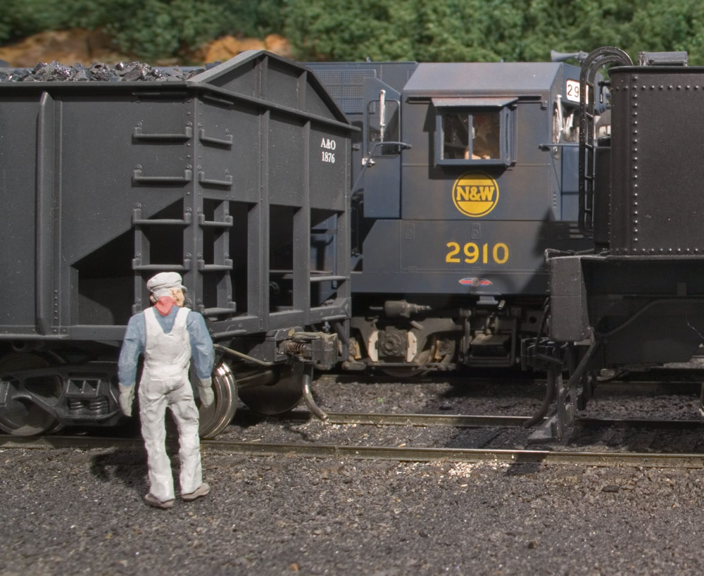  An A&amp;O brakeman cuts loose yet another coal drag in Willow Creek coal marshalling yard under the watchful eye of the N&amp;W transfer from Bluefield. 