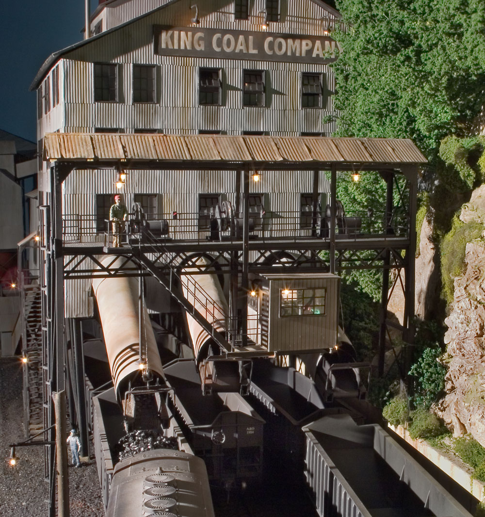  Coal is being dispensed from track one from the controls in the suspended operator house on the conveyor support A-frame. This structure was built of brass shapes and styrene. 