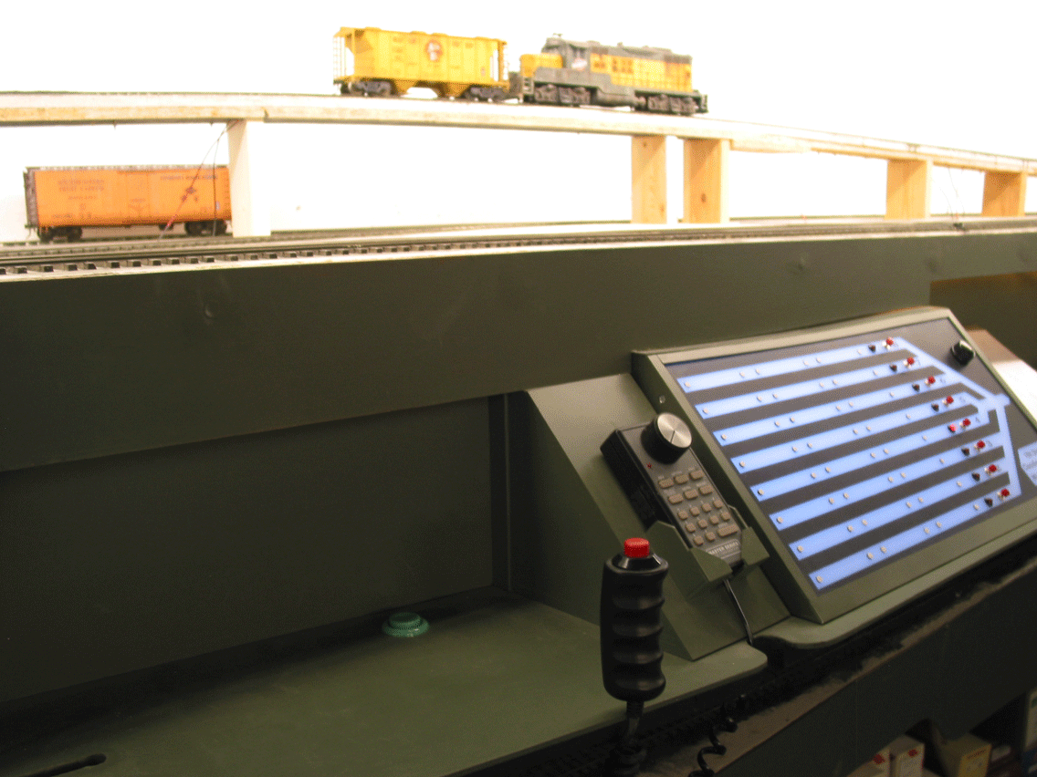  Activating the retarders is done by pressing either the green button on the shelf, or using the corded red push button on the hand grip- for walk along operation. A styrene cradle holds the hump engine cab throttle for the operator. A Back-emf decod