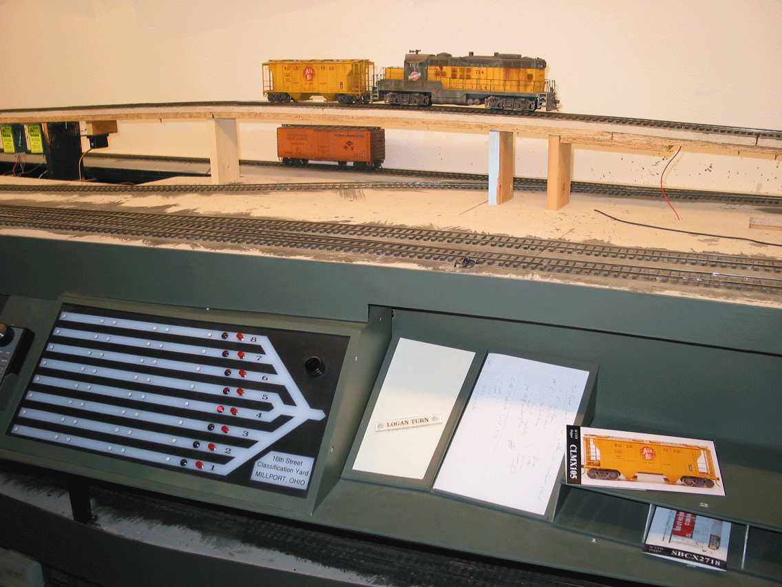  Work station for the 16th St. hump shows (left to right) panel with route selection, magnet board for "train tiles" which are placed on the panel to denote the train/track designation, a car-to-which-track list which is made up before the train is h