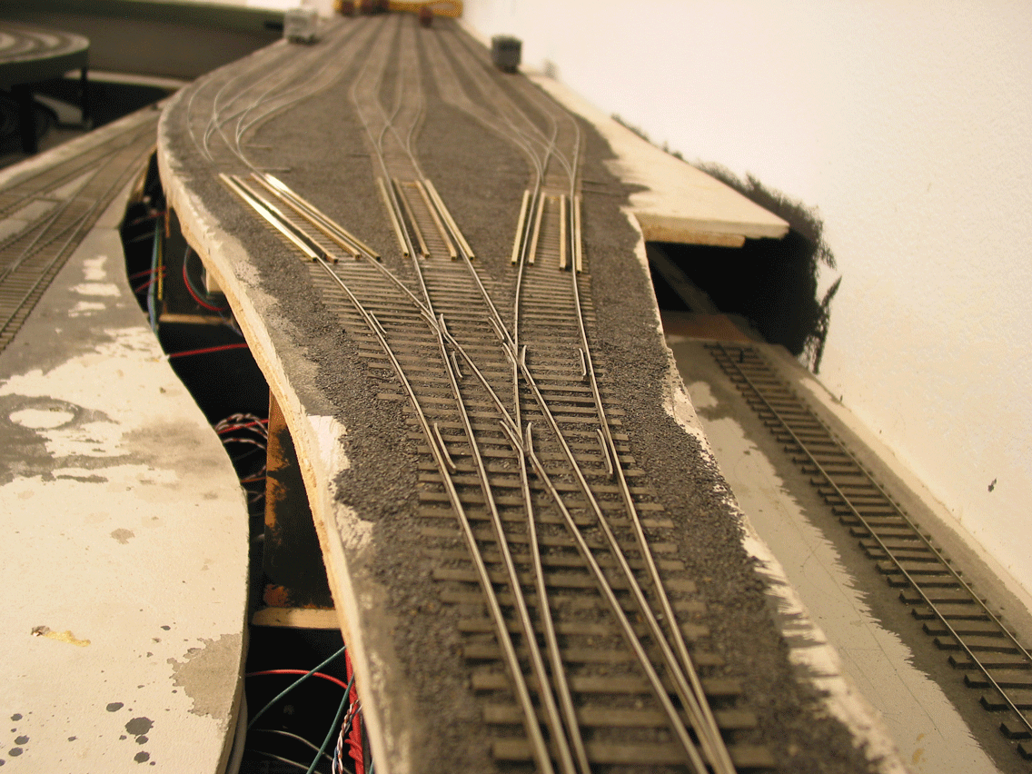 Having just passed the Master Retarder, we're entering the first 3-way to our appointed classification track. Group Retarders will further slow as needed per track capacity. Much time was spent creating the "bowl" so unretarded cars will run-out to the end if the track is empty. The trick is having a quick release grade followed by a continually diminishing grade over 75% of the track lengh. And then a slight upgrade at the end.