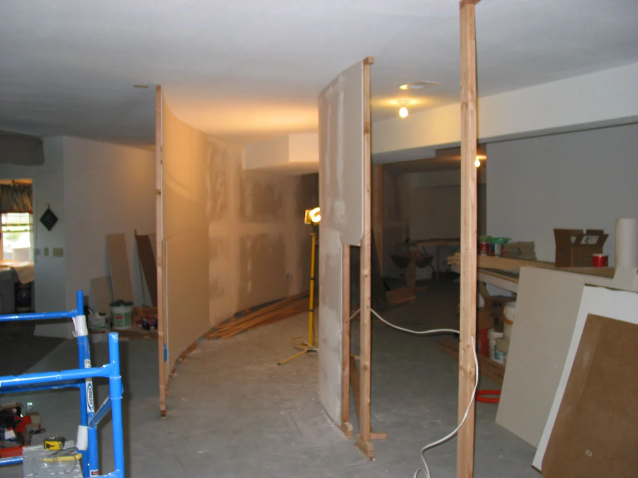 The three aisles are now visible as the walls grow. On the left is aisle to the rain scene at Ridge. The center aisle is the Kayford Valley, and the right is Morrison to Ricksburg aisle. It's feeling very different down here! Note Romex feeding thru studs for outlet boxes on these interior walls.