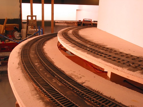  About mid-grade between the Ohio Bridge and Glen Forge. The Penn-Central staging tracks visible at the right and will be unseen, inside the hillside the A&amp;O is following upgrade. With super-elevation on the two mains, this should be a fun place 