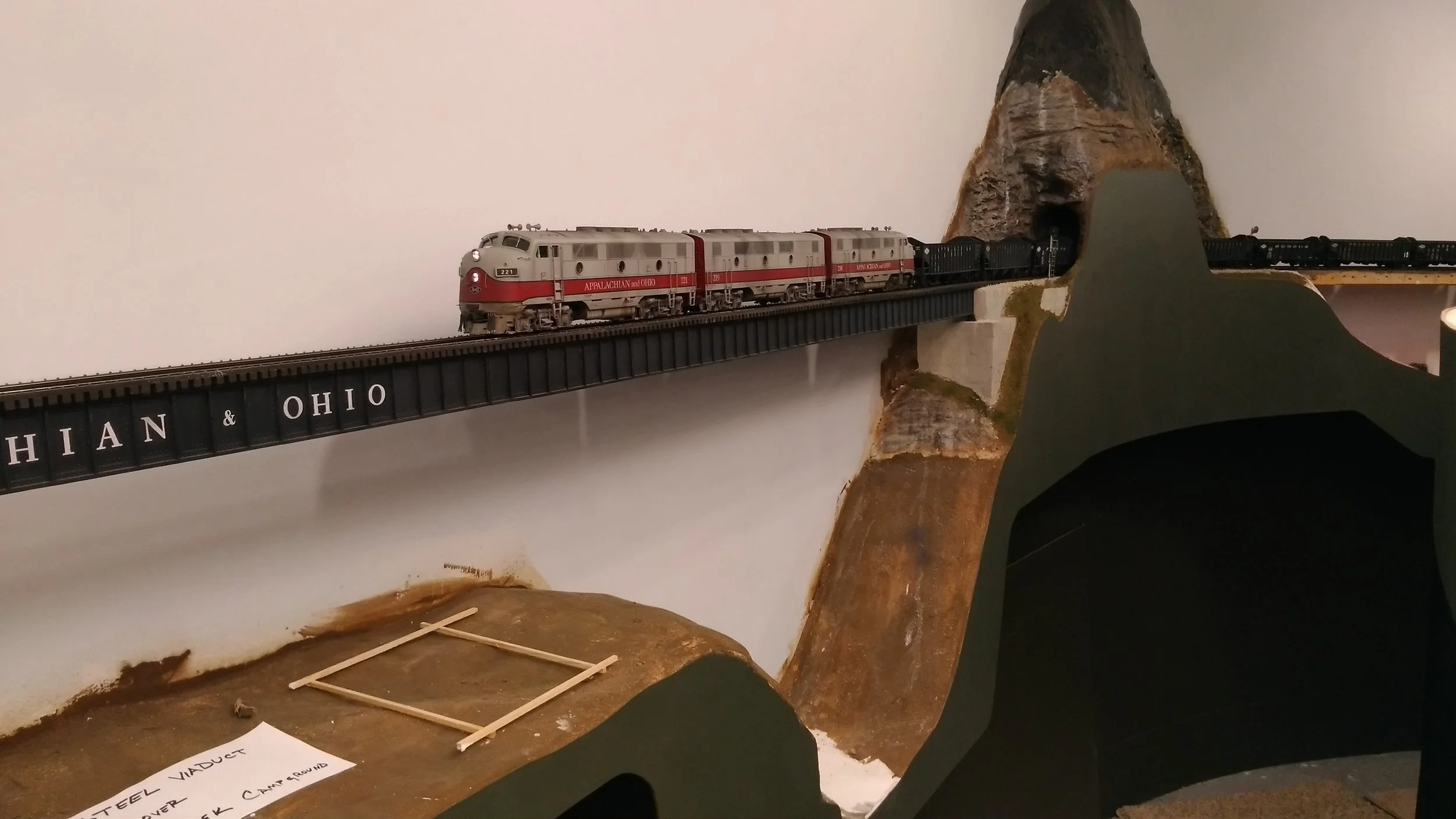 The stripwood rectangle identifies the location of one of the future support towers. The bridge is still removable at this point for doing the background painting.
