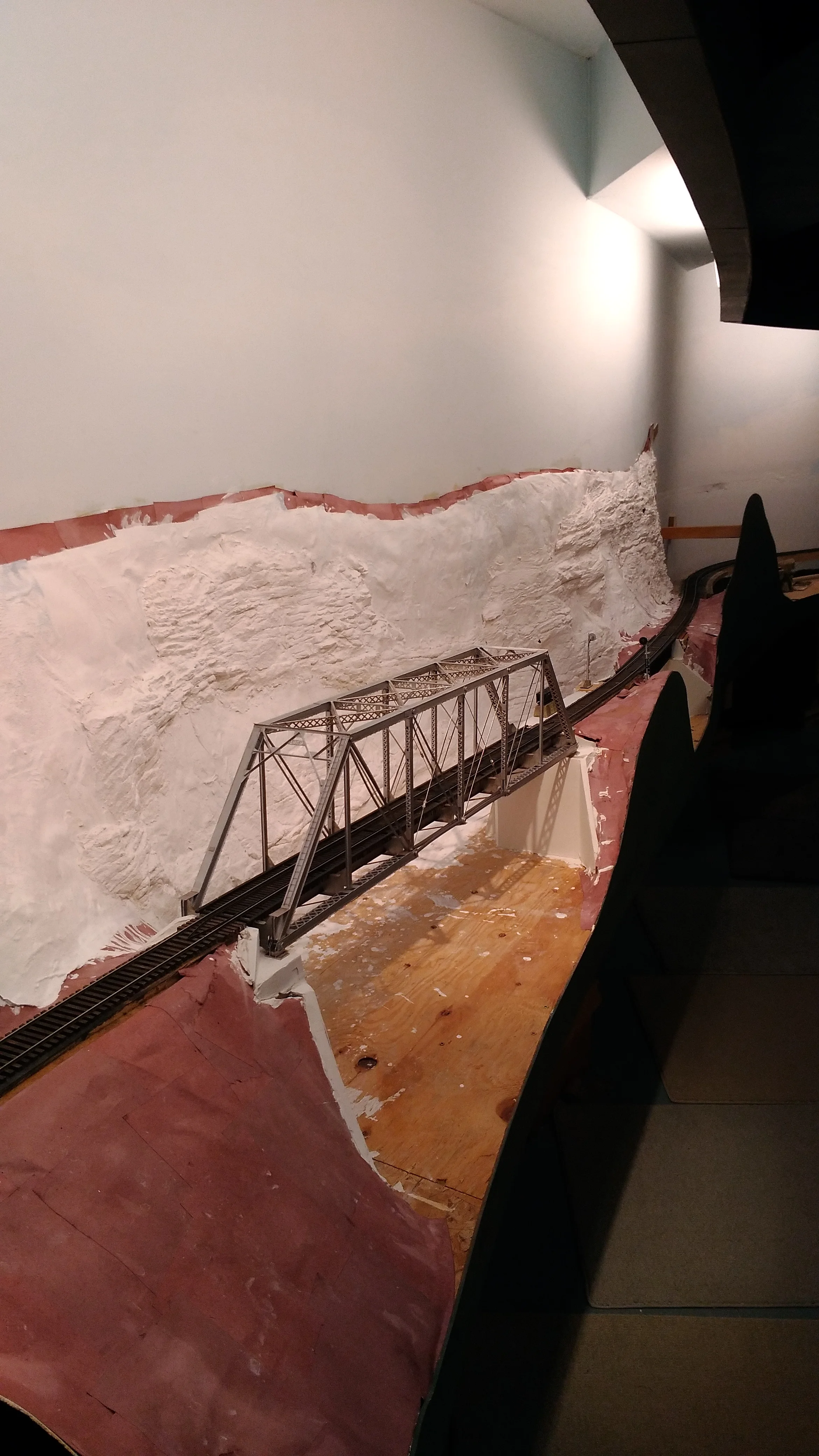 Scenery has begun in he Big Coal River gorge. And with the placement of the pin-connected bridge, the mainline was....(drum roll).....COMPLETED!! Appropriately, my long-suffering railroad-wife Katie ran the first train over the entire line. 