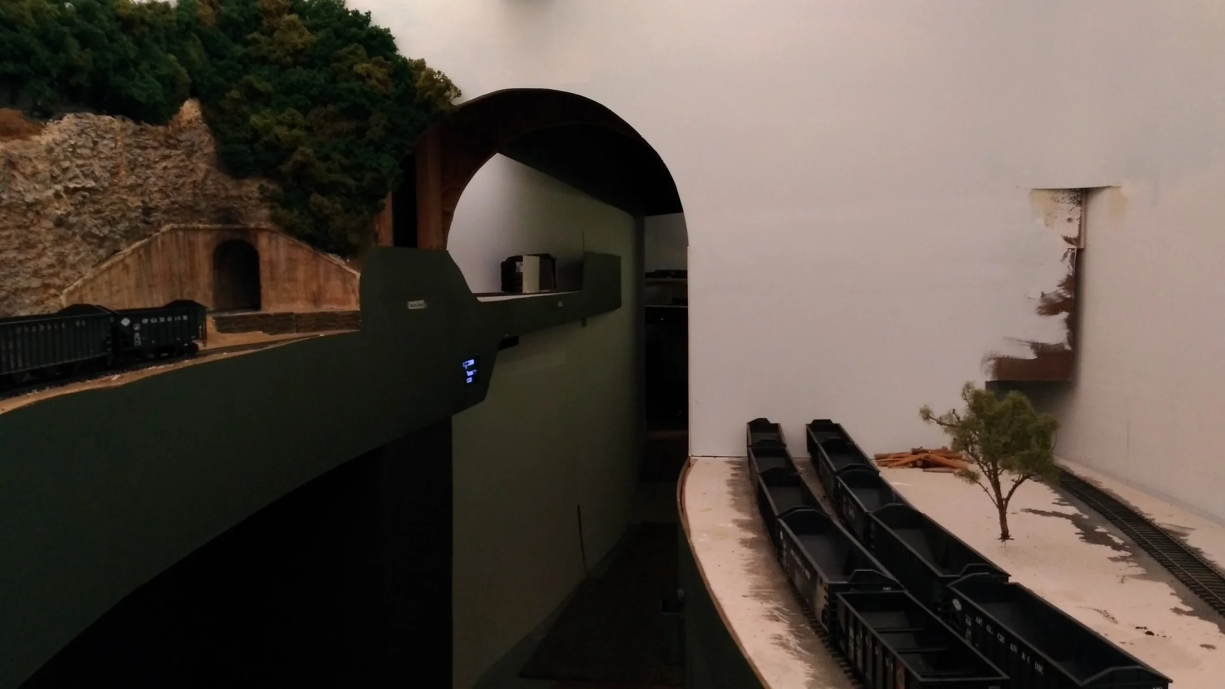 The far side of the Hawkins Loadout will sit flat against the scene divider wall, suggesting the tracks continue beyond it, further down the valley. Some painting required. The main, meanwhile, has disappeared into another tunnel for the next vignette. Across the aisle is Rockcut Tunnel and Apex beyond that. The elevation change is now readily apparent. 